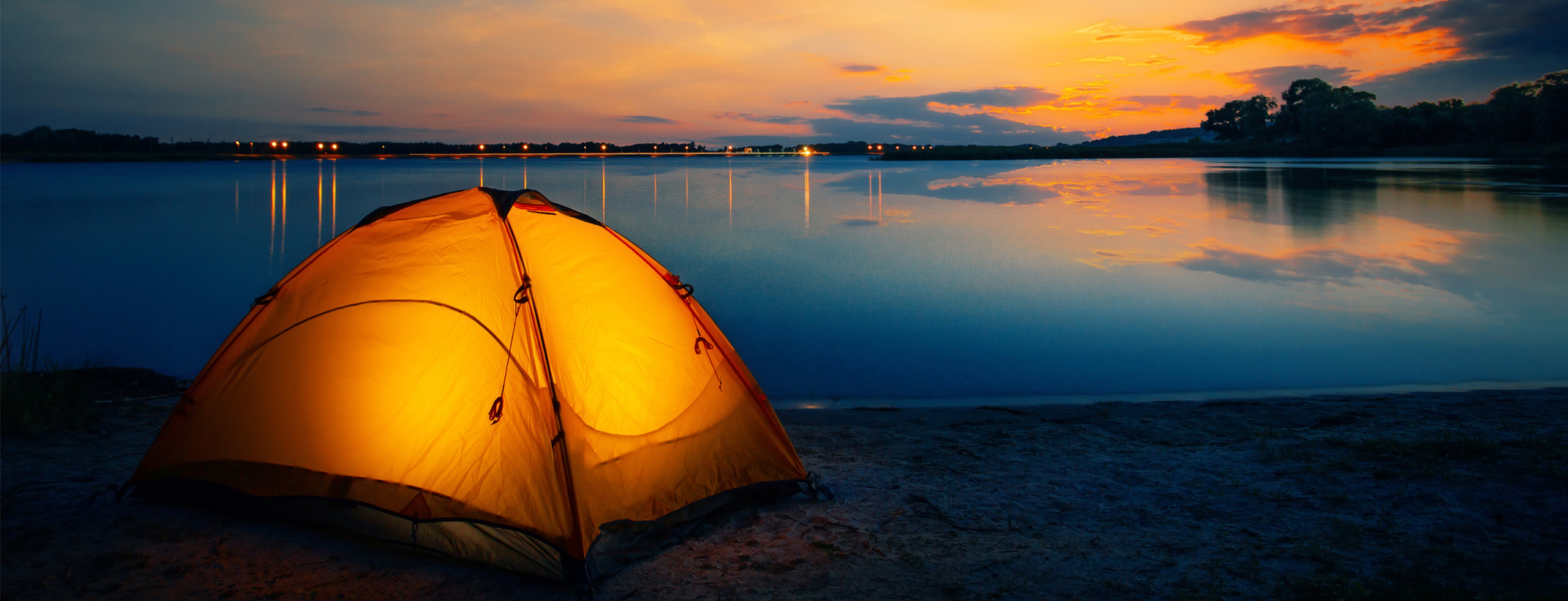 Tents on a beach in the evening.